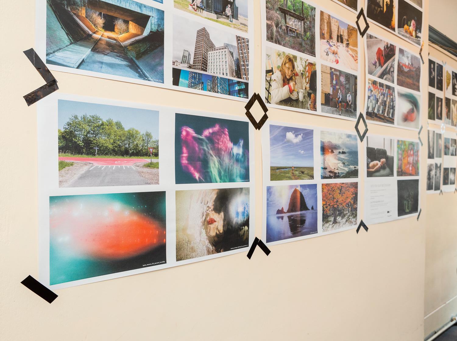 Photograph in the Gallery Café at St. Margaret's House, showing an exhibition of photographs printed on newsprint