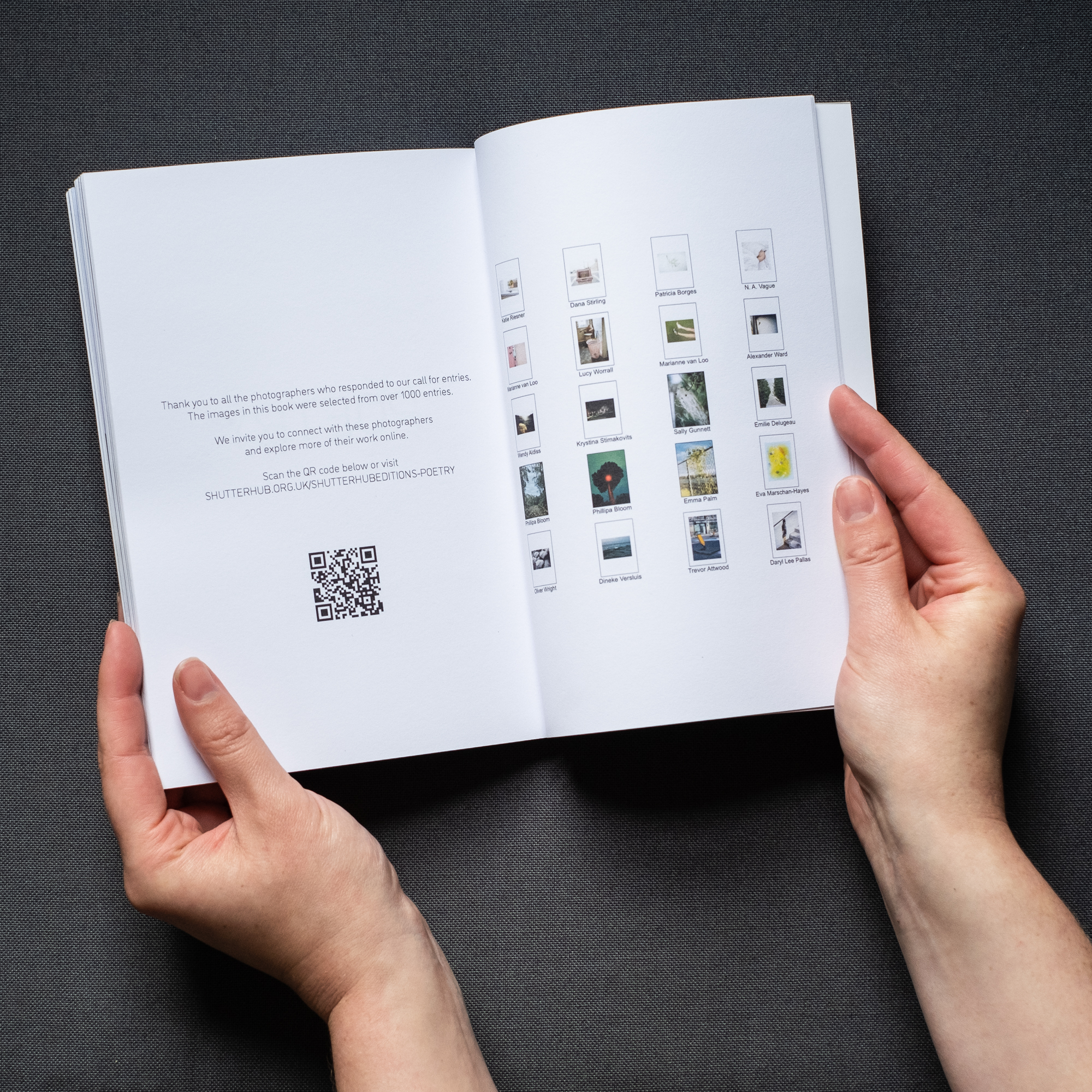 Photograph of hands holding a book open on a dark grey background. On the left page is text saying 'Thank you to all the photographers who responded to our call for entries. The images in this book were selected from over 1000 entries. We invite you to connect with these photographers and explore more of their work online.' and a QR code. On the right are thumbnails of images from the book.